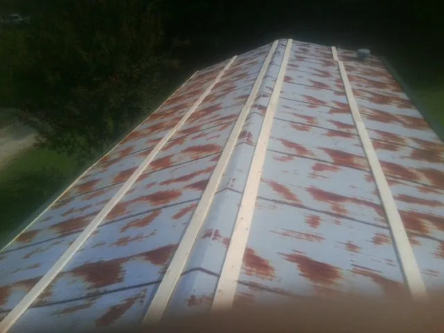 Rusted metal roof panels with new wood purlins before replacement — Storm Damage Roof Repair in Waynesburg by Roofing Brothers
