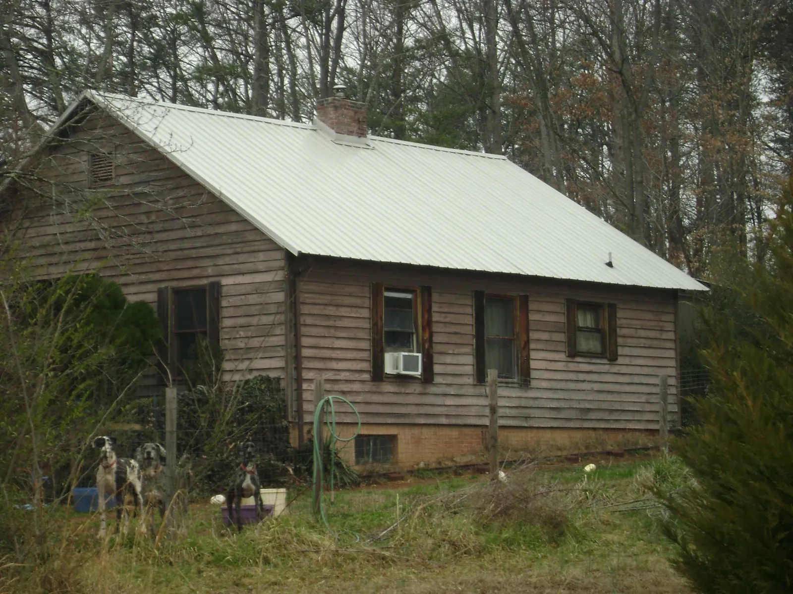 White metal roof on an old wood sided farmhouse, from a Metal Roof Installation job in Waynesburg